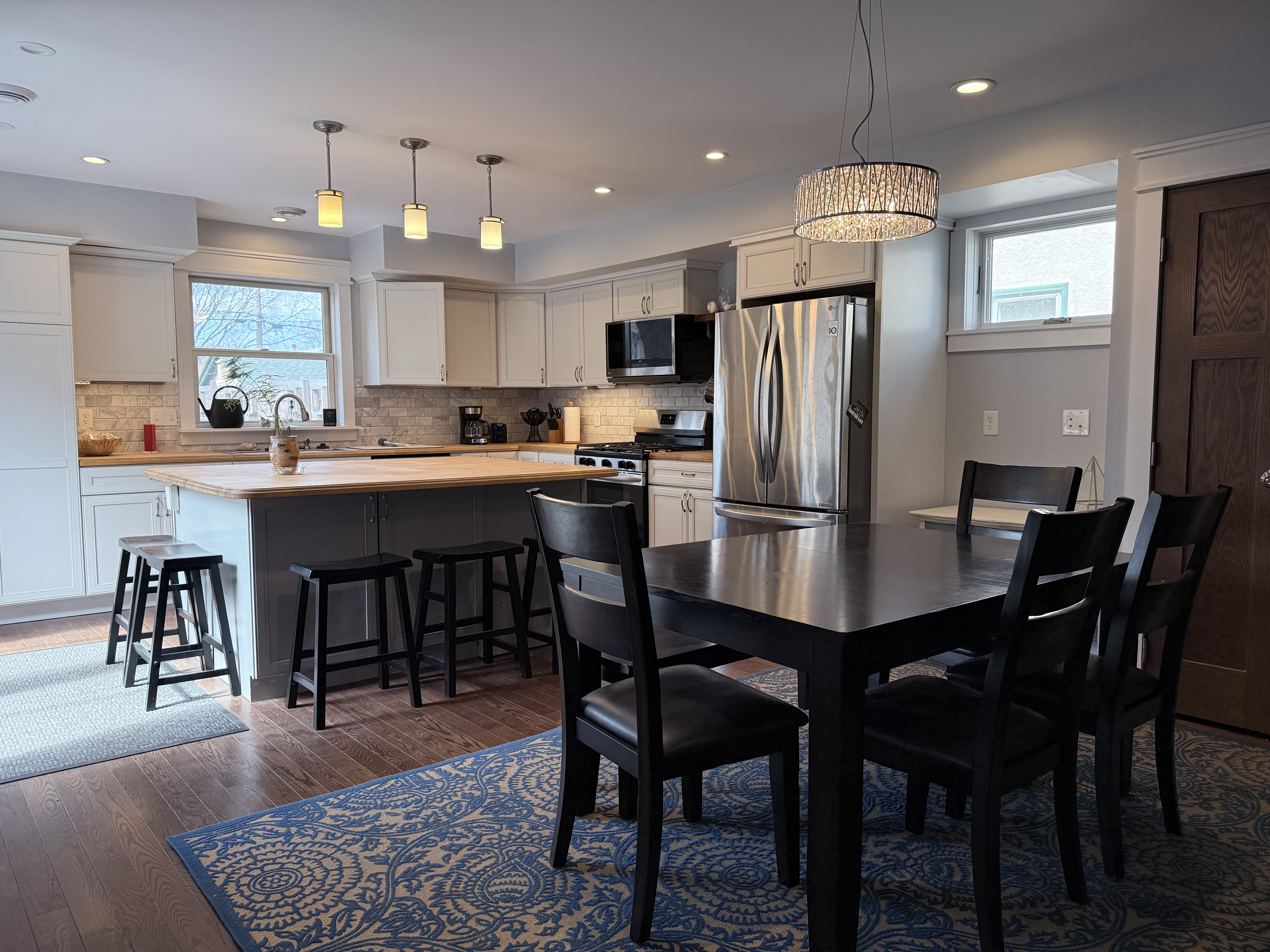 The Fifth — open-concept kitchen and dining with island and pendant lights