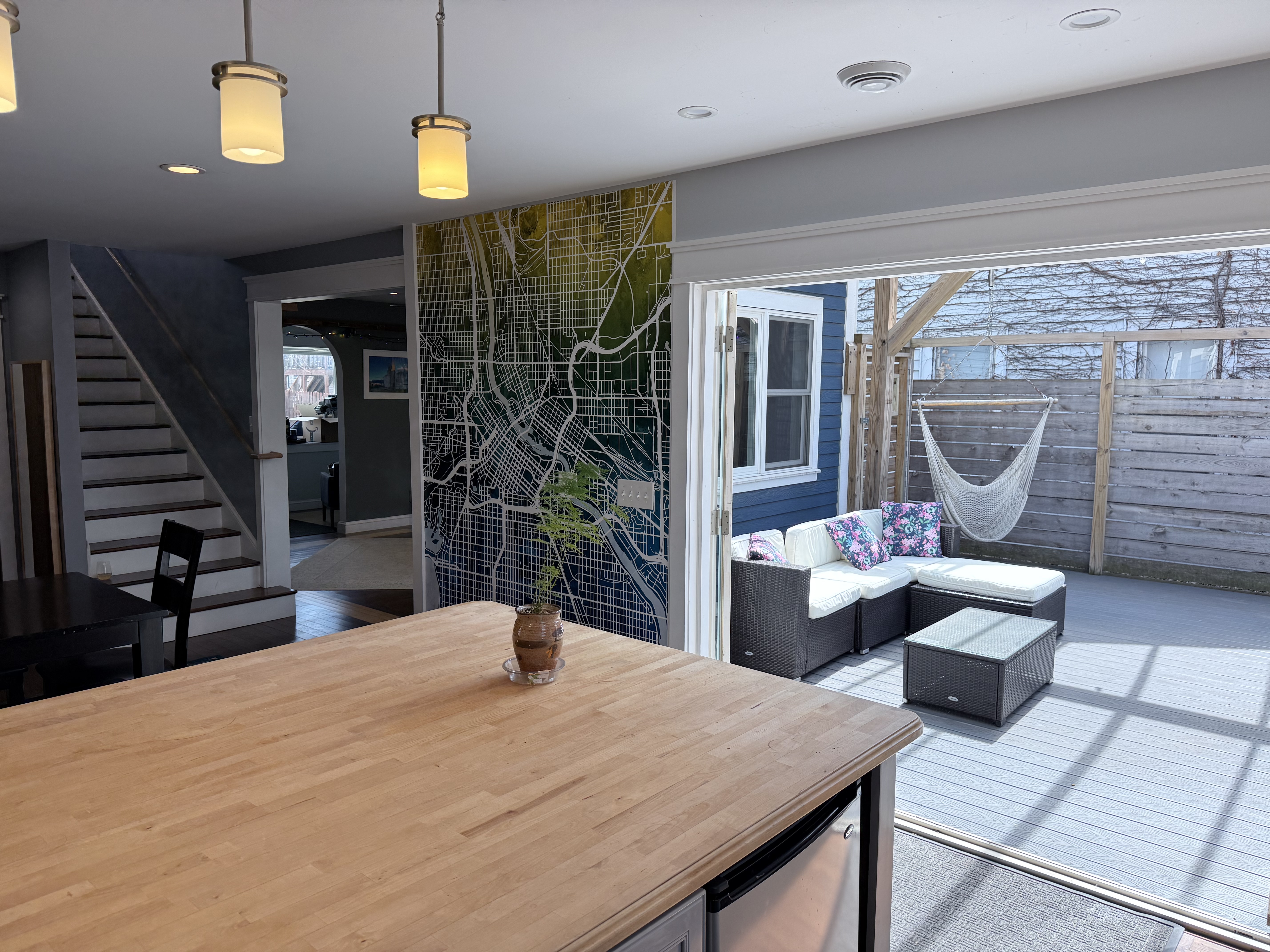 Kitchen island looking out to deck with outdoor furniture