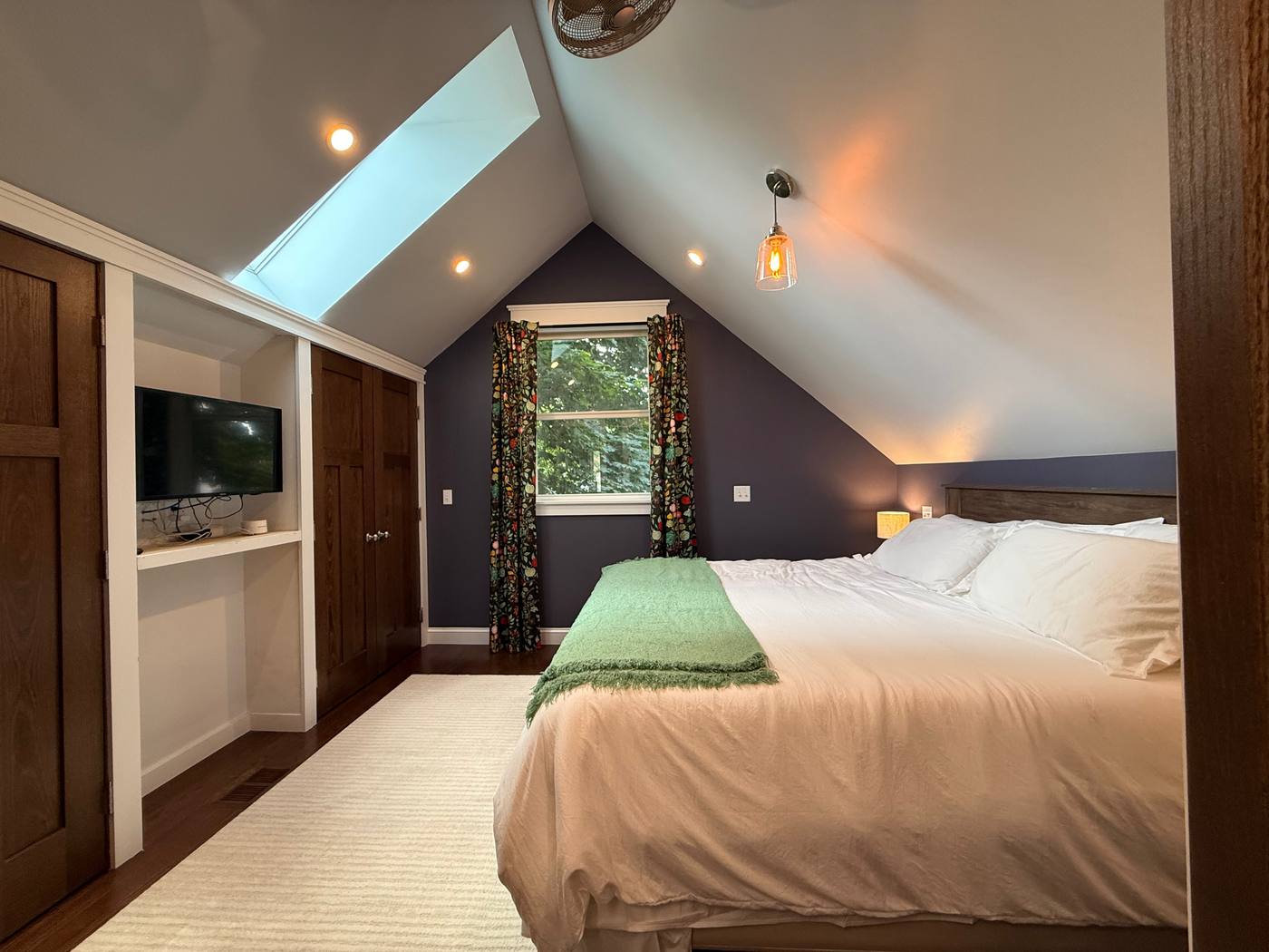 Upstairs bedroom with skylights, TV alcove and built-in closets